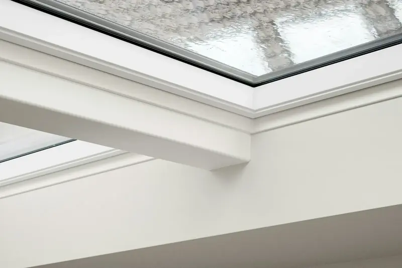 A flush roof light set into a white sloping ceiling