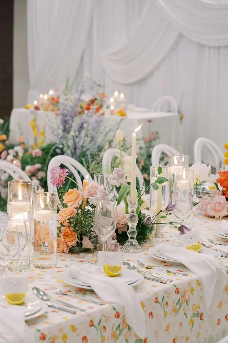 Long table laid with spring flowers and candles